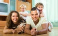 Family of four playing with kitten Royalty Free Stock Photo