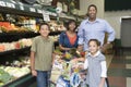 Family Of Four Shopping In Supermarket