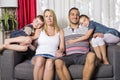 Family of four on the sofa in the living room Royalty Free Stock Photo