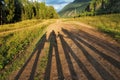 a family of four is standing on a country road, only their shadow is visible. holding hands, rallying Royalty Free Stock Photo