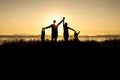 Family of four at sunset shadow black backlit Royalty Free Stock Photo