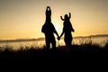 Family of four at sunset shadow black backlit Royalty Free Stock Photo