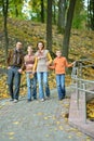 Family of four walking in autumn park Royalty Free Stock Photo