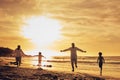 Family, freedom with silhouette on beach at sunset, parents and kids running together with travel, care free and happy Royalty Free Stock Photo