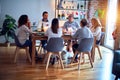 Family and friends dining at home celebrating christmas eve with traditional food and decoration, all sitting on the table Royalty Free Stock Photo