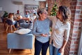 Family and friends dining at home celebrating christmas eve with traditional food and decoration, women talking together happy and Royalty Free Stock Photo