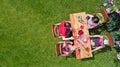 Family and friends eating together outdoors on summer garden party. Aerial view of table with food and drinks from above Royalty Free Stock Photo