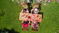 Family and friends eating together outdoors on summer garden party. Aerial view of table with food and drinks from above Royalty Free Stock Photo