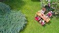 Family and friends eating together outdoors on summer garden party. Aerial view of table with food and drinks from above Royalty Free Stock Photo