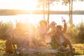 Family and Friends Enjoying Lakeside Picnic at Sunset