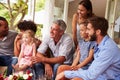 Family and friends gathered in a conservatory Royalty Free Stock Photo