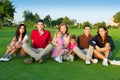 Family friends group people sitting green grass Royalty Free Stock Photo