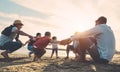 Family friends having fun on the beach at sunset - Fathers, mothers, children and uncles playing together - Love, relationship, Royalty Free Stock Photo