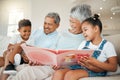 Family and friends are hidden treasures. grandparents bonding with their grandchildren on a sofa at home.