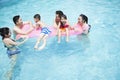 Family and friends playing in the water at the pool Royalty Free Stock Photo