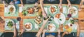 Eating and leisure concept - group of people having dinner at table with food