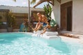 Family Fun In Pool. Father And Son Jumping On Floating Inflatable Water Mattress Together.