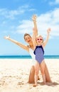 Happy young mother and daughter on seashore rejoicing Royalty Free Stock Photo