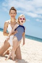 Smiling mother and child in swimsuits at beach on a sunny day Royalty Free Stock Photo