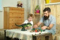 Family game. Child, father and dinosaur. Childrens hobbies. Boy and dad. Royalty Free Stock Photo