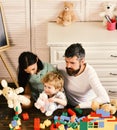 Family games concept. Kid boy, mother and father play builders in nursery Royalty Free Stock Photo