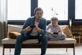 family, gaming and entertainment concept - happy father and little daughter with gamepads playing video game at home. Royalty Free Stock Photo