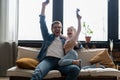 family, gaming and entertainment concept - happy father and little daughter with gamepads playing video game at home. Royalty Free Stock Photo