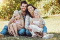 Family, garden and portrait of parents, children and happy people on park grass in sunshine. Kids, mom and dad smile