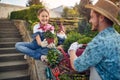 Family Gardening Fun: Father and Daughter Sharing a Flower Pot with Joy Royalty Free Stock Photo