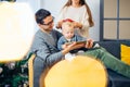 Family gathered around a Christmas tree, using a tablet Royalty Free Stock Photo