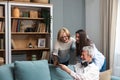 Family gathering. Father, Mother and daughter in the family home, reminisce about the past by looking at old photos from their Royalty Free Stock Photo