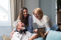 Family gathering. Father, Mother and daughter in the family home, reminisce about the past by looking at old photos from their Royalty Free Stock Photo