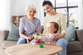 Mother, baby daughter and granny playing at home Royalty Free Stock Photo