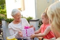 Granddaughter giving present to grandmother Royalty Free Stock Photo