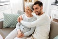 Senior mother with adult son hugging at home Royalty Free Stock Photo