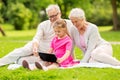 Grandparents and granddaughter with tablet pc Royalty Free Stock Photo