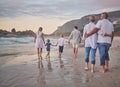 Family, generations and back with walking, beach and sunset with men, women and children with love. Parents Royalty Free Stock Photo