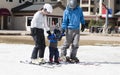 Family Gets Ready to Ski with Toddler Boy. All Dressed Safely with Helmets Royalty Free Stock Photo