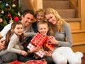 Family with gifts in front of Christmas tree Royalty Free Stock Photo