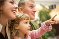 Family with girl with hand pointing finger forward