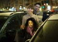 Family with girl posing near car outdoors in winter Royalty Free Stock Photo