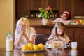 Family, girls, children eating at the table in the kitchen