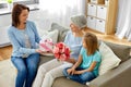 Family giving present and flowers to grandmother Royalty Free Stock Photo