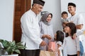 family giving present to their muslim grandparents during eid mubarak celebration Royalty Free Stock Photo