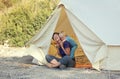 Family glamping outdoor vacation. Mother and her toddler son sitting near big camping tent with cozy interior. Luxury travel