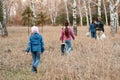 Family goes in the autumn woods