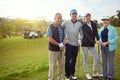 Family golf day. Portrait of a family of four enjoying a day on the golf course. Royalty Free Stock Photo