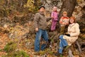 Family with grandfather in autumnal forest