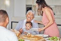 Family, grandmother and baby with food at the dining room or kitchen table for mothers day. Happy mother, father and Royalty Free Stock Photo