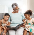 Family, grandmother and children with book reading on sofa for bonding, relaxing and quality time together. Love Royalty Free Stock Photo
